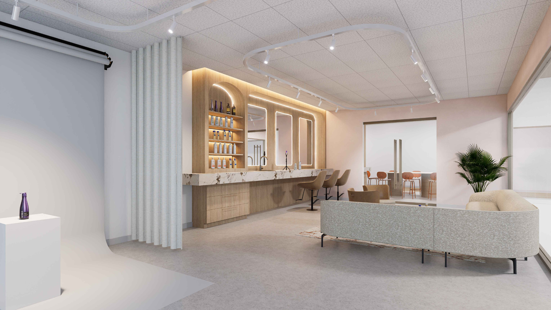 Salon space with lighted mirrors, product shelves and high backed chairs. Soft couch seating if seen in front of that space.