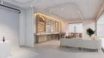 Salon space with lighted mirrors, product shelves and high backed chairs. Soft couch seating if seen in front of that space.