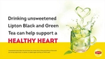 A cup of hot green tea splashing out of cup