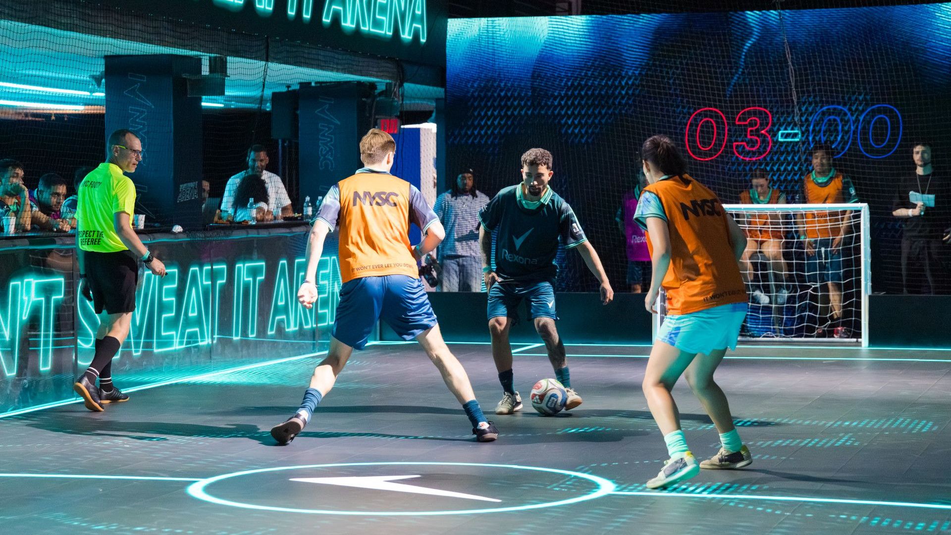 Men play on an LED football pitch at Unilever's House of Fresh. A Rexona logo is illuminated on the floor.
