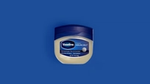 Jar of Vaseline Original Healing Jelly on a blue background.