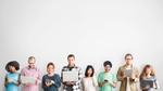 People in a row holding their devices