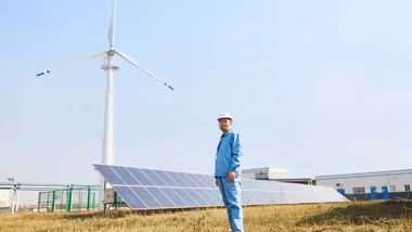 Man stood in front of solar panels