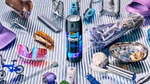 A flatlay photo with a can of Axe Blue Lavender fine fragrance deodorant spray in the centre. Also pictured are sunglasses, a Nintendo controller, a razor and a spray of lavender.
