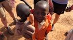 A young boy with his thumb up