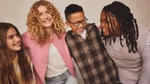 A pic from a Dove campaign of four young teenagers smiling and laughing together. There are three girls and one boy.