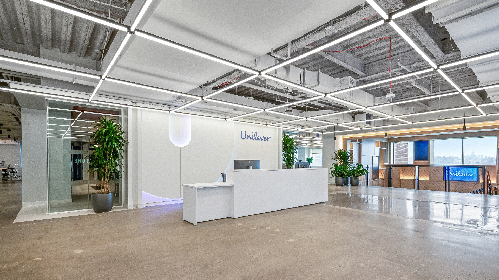 The reception desk in the new Hoboken Unilever office. Bright white desk with blue Unilever accents.